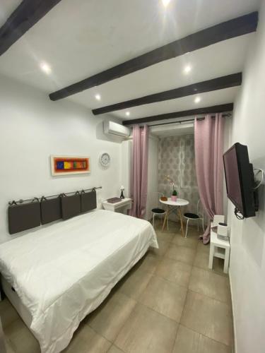 um quarto com uma grande cama branca e uma mesa em Casa Álvarez em Madri