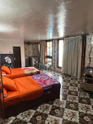 a bedroom with two beds and a fireplace at Nubian Dreams Guest House in Aswan
