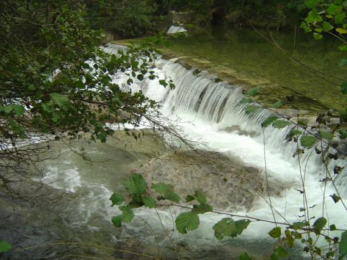 a waterfall in the middle of a river at Auberge Cocagne in Avèze