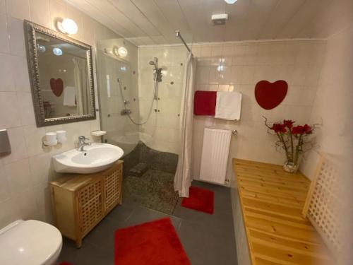 a bathroom with a toilet and a sink and a shower at Appartement Resch in Mariapfarr