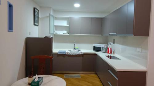 a small kitchen with a sink and a refrigerator at Regalia Suite Studio in Kuala Lumpur
