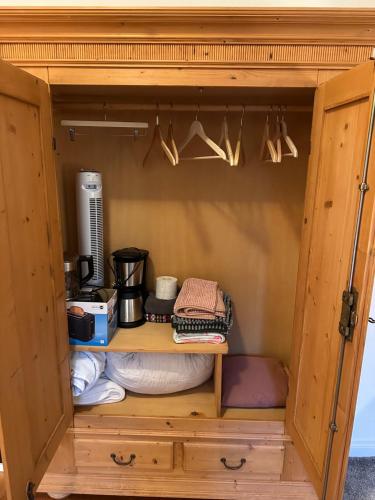 a cupboard with hangers and utensils in it at Inspiration in Schwanewede