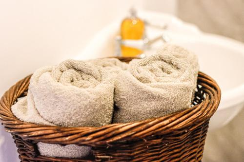 a basket filled with towels next to a sink at Stunning Lodge with Hot Tub on Private Lake in Harrogate