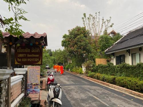 a motorcycle parked on the side of a street at Liberty Place in Luang Prabang