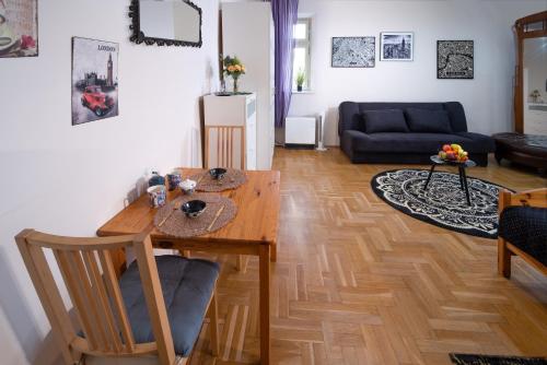 a living room with a wooden table and a couch at Cozy Apartament Rachel-Near Rynek and train station in Krakow