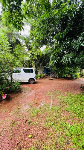 a white van parked in front of a house at Kataragama Homestay in Kataragama