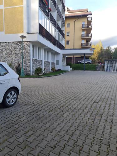 a car parked in front of a building at Apartmán Horný Smokovec in Smokovce