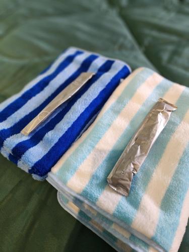 a pair of towels sitting on top of a bed at 812 Quiet AC Apartment with Balcony & free Wifi in Bangkok
