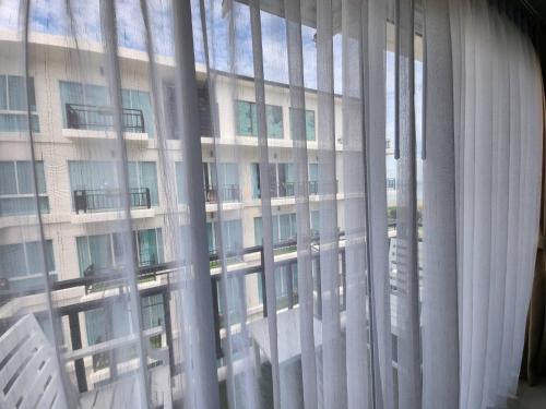 a view of a large building through a window at LHC HOTEL AND RESORT in Pattaya Central