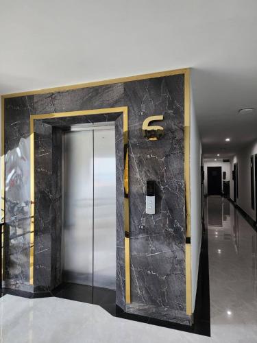 a elevator in a building with a large stone wall at LHC HOTEL AND RESORT in Pattaya Central