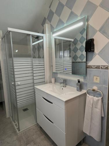 a bathroom with a white sink and a shower at Hostal Cabañeros in Ciudad Real