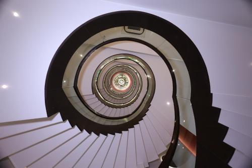 a view of a spiral staircase in a building at Hotel Godwin Deluxe - Free Airport Pick-Up in New Delhi