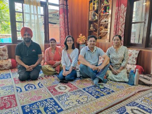 a group of people sitting on the floor in a room at Sea Green Guest House in Srinagar