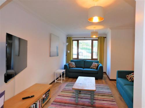a living room with a couch and a table at Railway View in Cromer