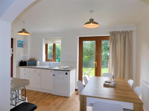 a kitchen and dining room with a table and a dining room at Railway View in Cromer