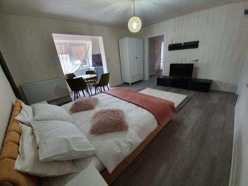 Un dormitorio con una cama grande con almohadas. en Villa Coca, en Câmpulung Moldovenesc