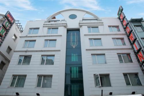 a white building with an arch over it at Hotel Godwin Deluxe - Free Airport Pick-Up in New Delhi