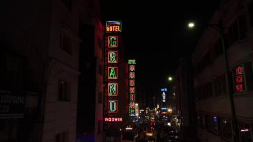 a building with neon signs on a city street at night at Hotel Godwin Deluxe - Free Airport Pick-Up in New Delhi