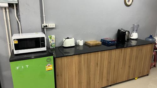 a microwave oven sitting on top of a counter at W District hostel in Bangkok