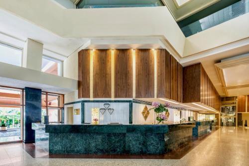 a large kitchen with wooden cabinets and a counter top at Grand Fiesta Americana Coral Beach Cancun - All Inclusive in Cancún