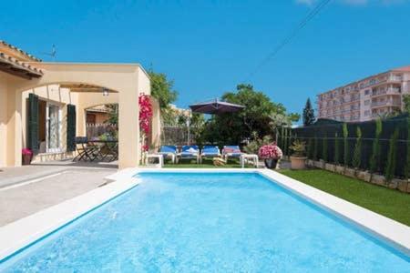 a swimming pool in the backyard of a house at Oleanda in Port d'Alcudia