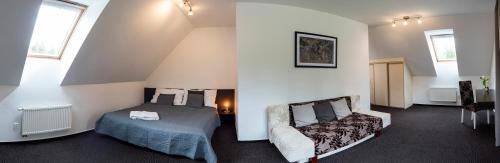 a bedroom with a bed and a chair in a room at Penzion Sileo in Pribylina