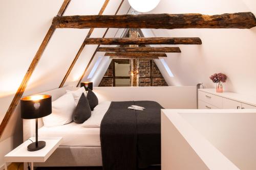 um quarto com uma cama branca e uma mesa em Johannis Suite - Schrangen-Suites-1389 em Lüneburg