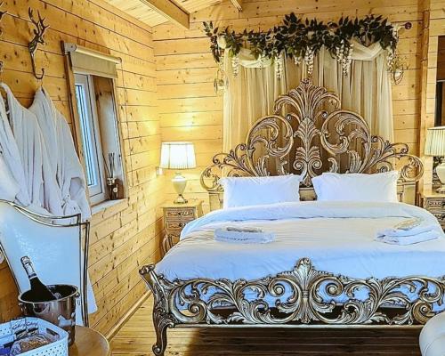 a bedroom with a large bed in a wooden room at Swan Lodge With Hot Tub Sauna and Treatments in Gainsborough