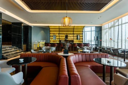a restaurant with leather couches and tables and a bar at Black Diamond Hotel in Lagos
