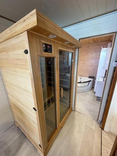 a wooden sauna with a glass door in a room at Splav Nala in Belgrade