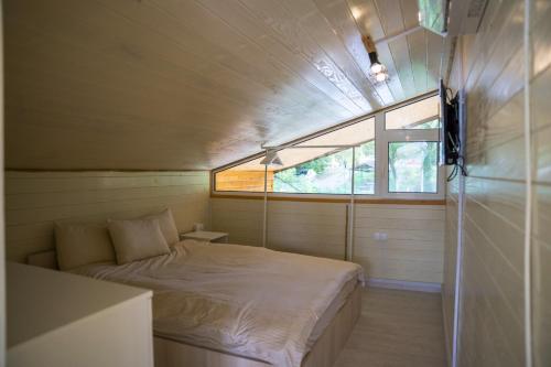 a small bedroom with a bed and a window at Splav Nala in Belgrade