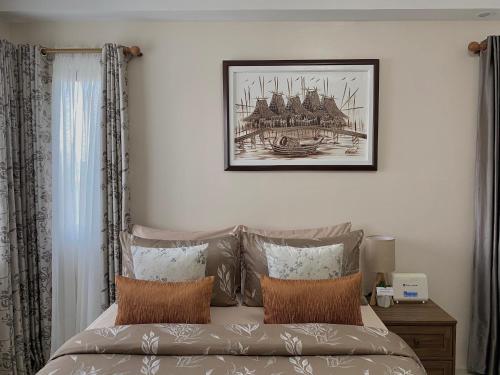 a bedroom with a bed and a picture on the wall at Condo , WIFI up to 100mbps , Infinity Pool in Cebu City