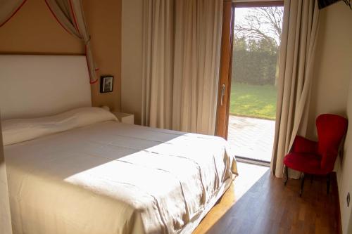 a bedroom with a bed and a sliding glass door at Masseria Olivola in Benevento