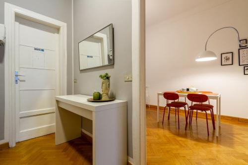 米兰CentralStation - Via Lazzaroni的厨房以及带桌子和镜子的用餐室