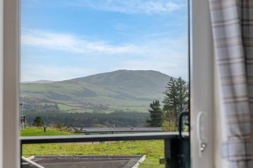 a view of a mountain from a window at Birch Timber Holiday Lodge in Bassenthwaite