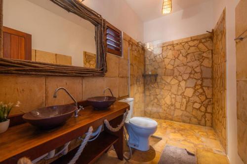 a bathroom with two sinks and a toilet at Barraca do Kite in Itarema