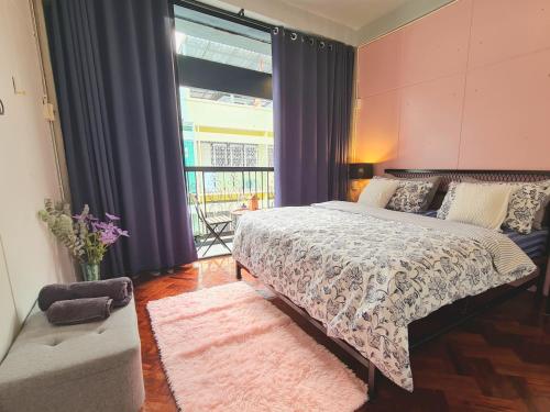 a bedroom with a bed and a large window at MEEMAW'S House Hostel in Bangkok