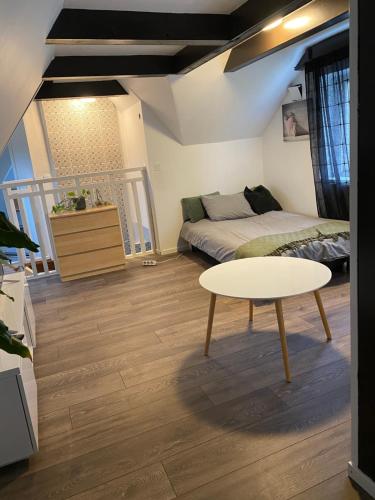 a small bedroom with a bed and a table at Bli Hel in Malmö