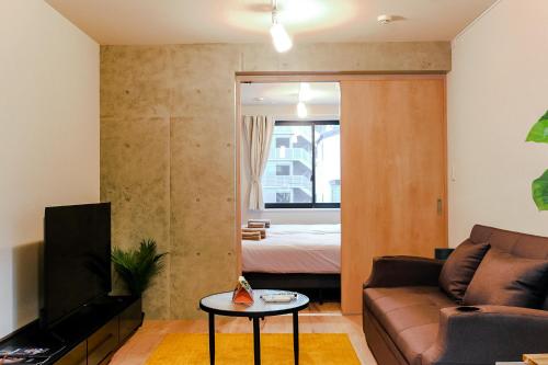 a living room with a couch and a bed at Seirai Asakusa Vacation Rental - 3 minutes from station in Tokyo