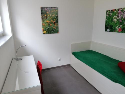 a room with a bed and two paintings on the wall at Moderne 3-Zimmerwohnung Rottweil Zentrum in Rottweil