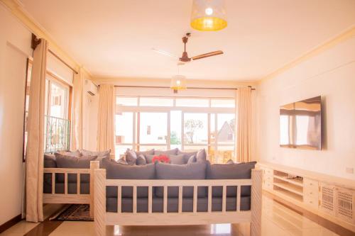 a living room with a couch in front of a window at Jumeirah Beachfront in Mombasa