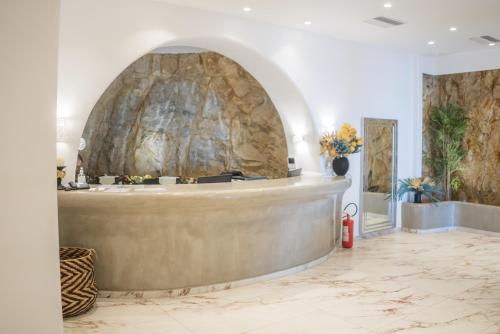 a lobby with a large stone wall at New Paradise Beach Resort in Paradise Beach