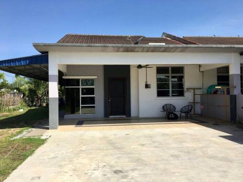 a small white house with a large patio at Zara Dija Homestay Klia/Klia2 in Sepang