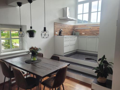 a kitchen with a table and chairs in a room at Appartement Lockei in Eben im Pongau