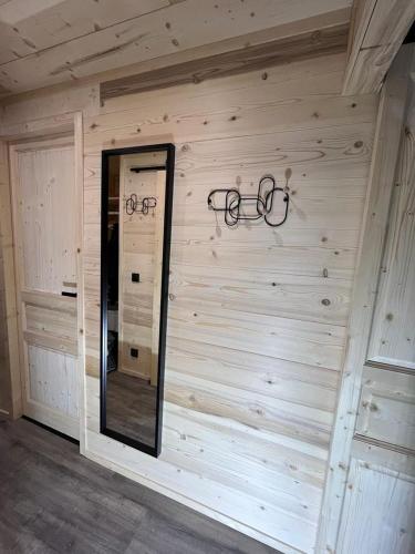 a room with a wooden wall with glasses on it at Les appartements de Makalu Val Thorens in Val Thorens