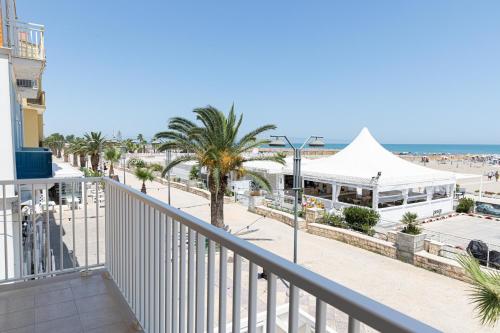 a balcony with a view of the beach and the ocean at 16TH FAD ROOMS in Margherita di Savoia