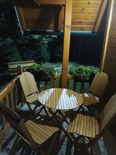 two chairs and a table on a patio at Fruskogorske brvnare in Velika Remeta