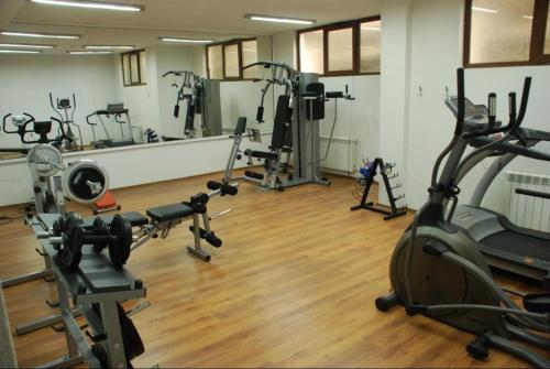 a gym with several treadmills and exercise bikes at Private Suite at Comfort Bansko in Bansko