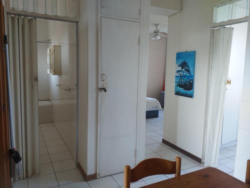 a bathroom with a door leading to a bathroom with a shower at Afsaal Sea view apartments in Amanzimtoti