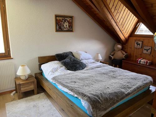 a bedroom with a bed with a wooden frame at Chalet Les Rhodos appartement le Yeti in Les Crosets